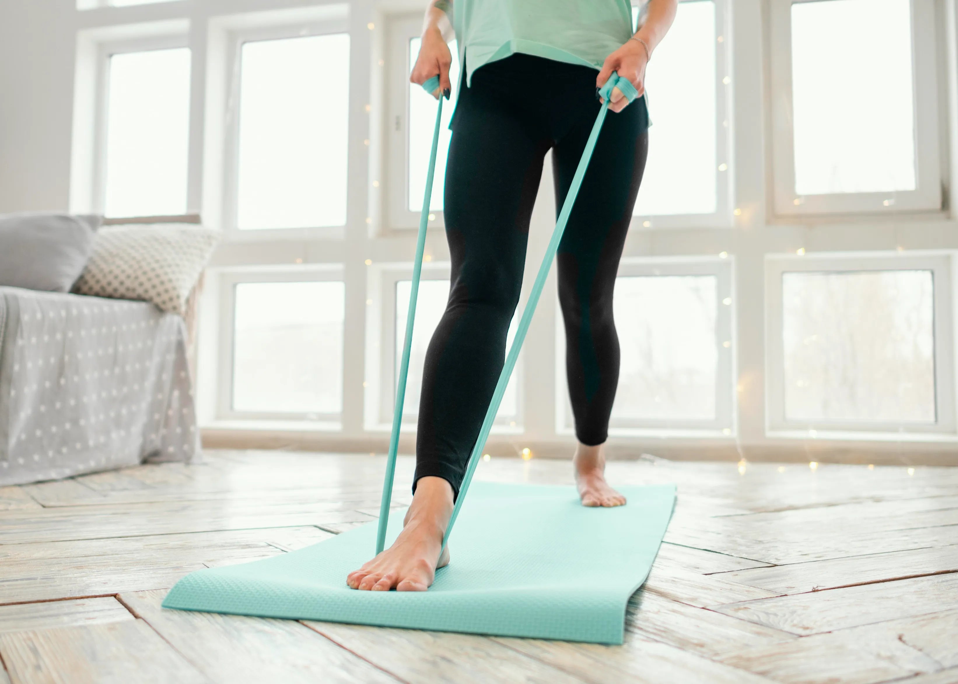 Female working out on mat with elastic band