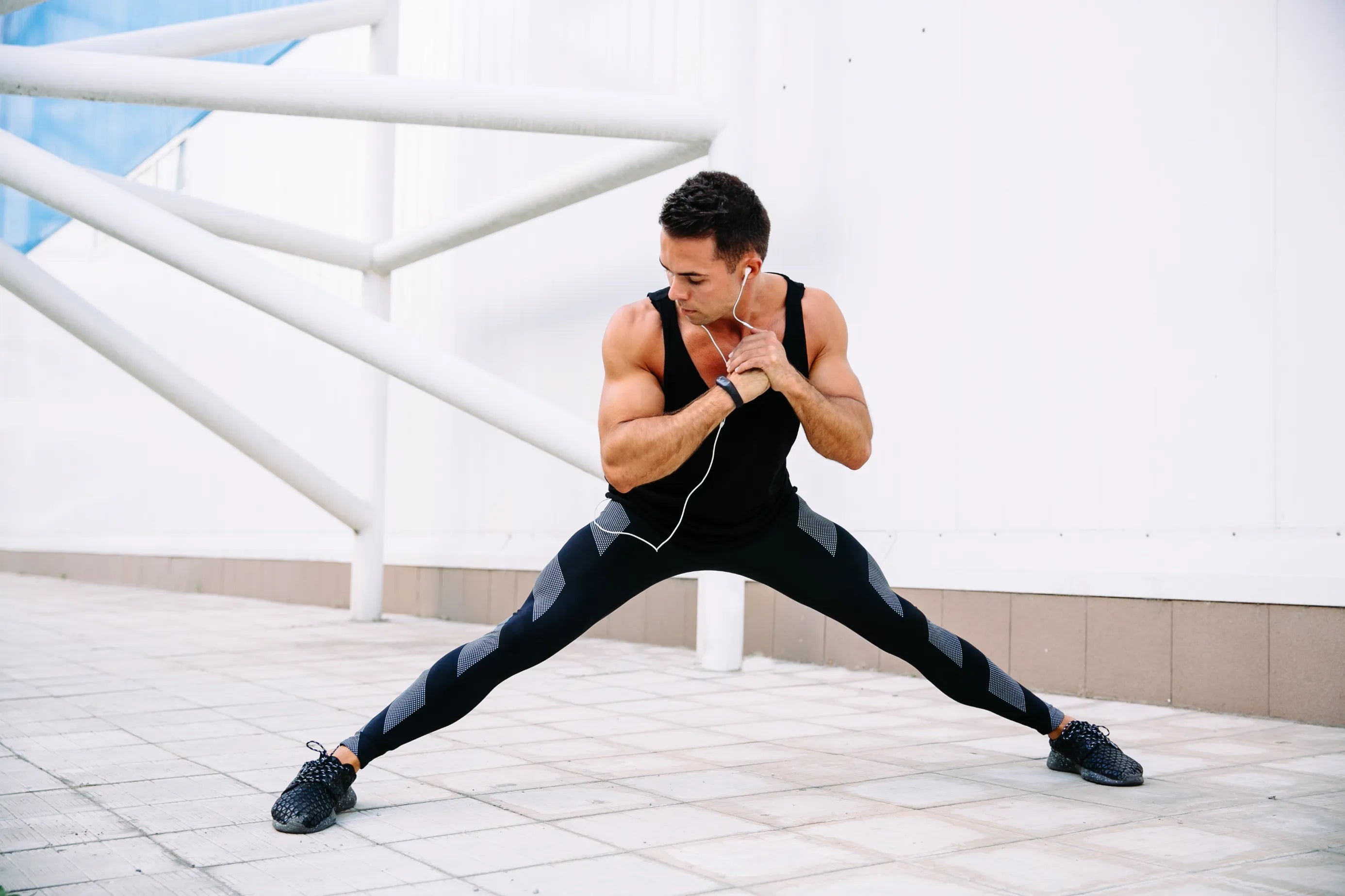 Full length view of athlete male doing physical exercise during workout outdoors.